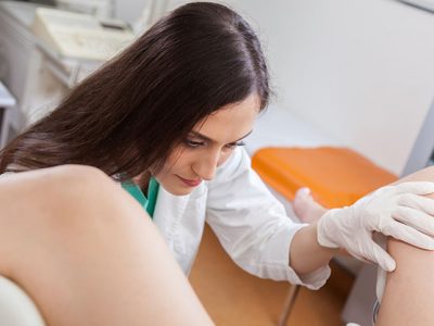 Young Female Gynecologist During Examination In Her Office