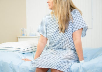 Mid-adult woman in gynecologist's office for her annual check up.  Women's health concept.